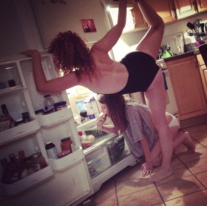 Alexandra Roxo doing yoga looking in the fridge. Click here to read why!