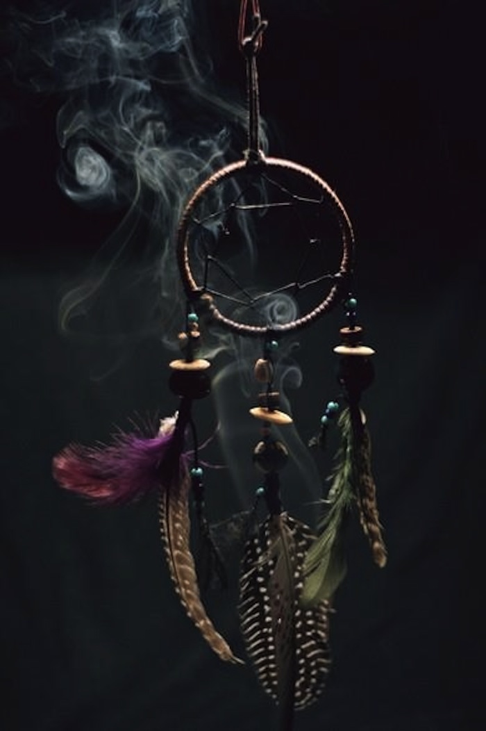 Dream catcher with sage smoke to illustrate article on smudging. Read more at TheNuminous.net!